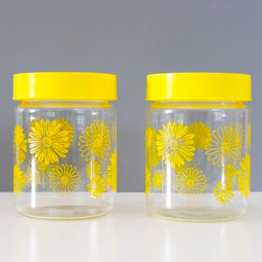 Vintage Corning Ware yellow glass storage jars with daisies
